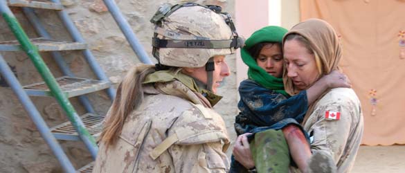 Canadian Armed Forces members help a young Afghan girl suffering from a burn.
