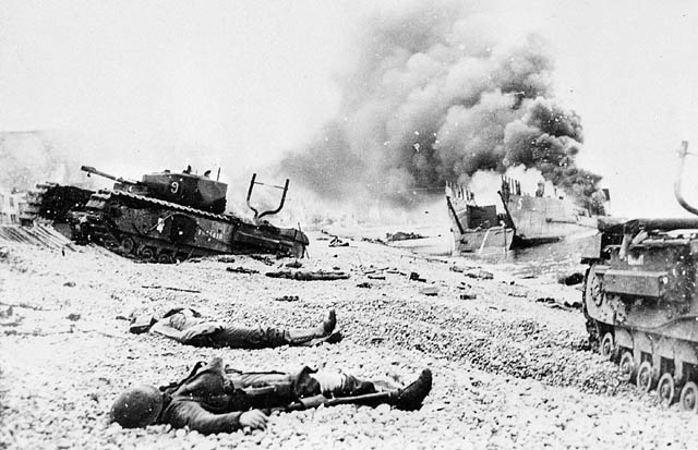 Fallen soldiers amid damaged tanks and landing craft on the beaches of Dieppe.