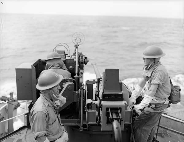 HMCS Iroquois crew members ready at their gun off the coast of Korea