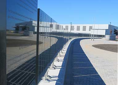 Side view of the 100-metre-long granite Memorial Wall displaying over 19,000 names.