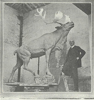 Sculptor Basil Gotto pictured with a model of the Caribou Monument