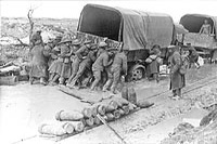 Canadians giving a lorry a helping hand on a shell battered road on Vimy Ridge, April 1917.
