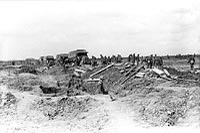 Laying road over "No Man’s Land" to our front line troops, April 1917.