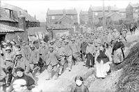 Germans captured by Canadians at Vimy Ridge passing through a French Village, May 1917.