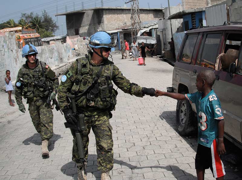 Canadian Armed Forces members on patrol in Port-au-Prince, Haiti, in June 2013