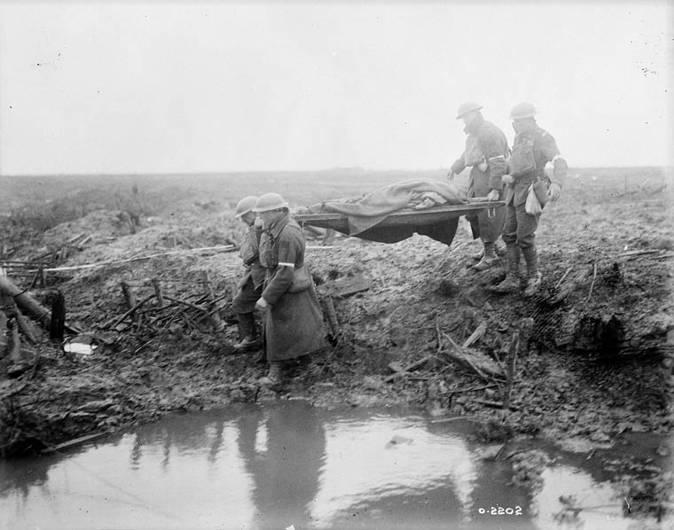 Canadian Pioneers laying trench mats over mud.