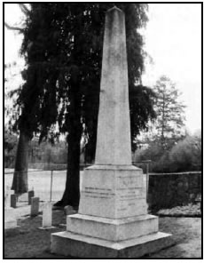 Tapered stone pillar, located at the cemetery entrance