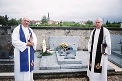 Padre Roland Murray and Father Grajcan Burkiciak at grave of Elise Legault