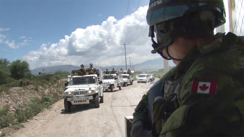 Canadian Armed Forces members in a convoy during an overseas operation.