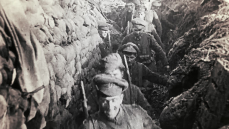 Allied soldiers walking through a trench during the First World War.