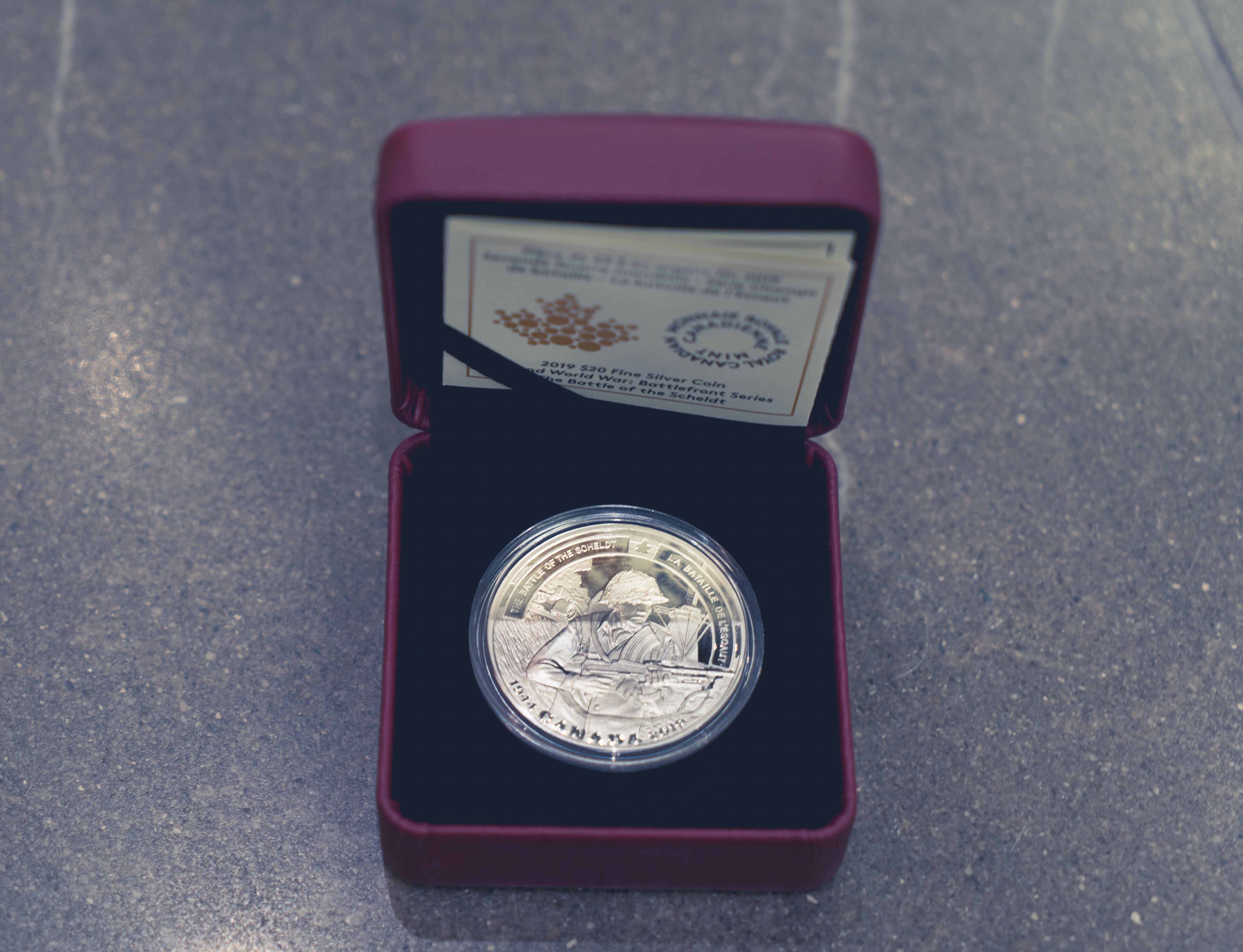 • Pièce de 20 dollars en argent fin de la Monnaie royale canadienne qui souligne le 75e anniversaire de la bataille de l’Escaut. 