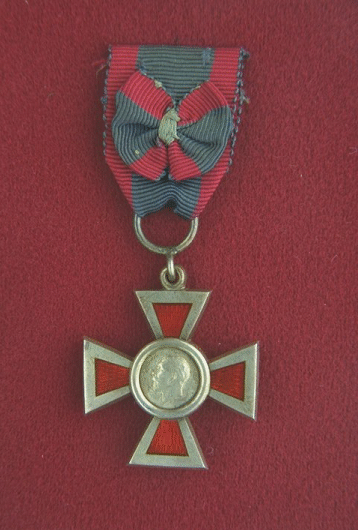 Royal Red Cross Class 2.  A cross, 1.375 inches wide, frosted silver, with a Maltese cross enamelled red superimposed thereon and a circular medallion at its centre.