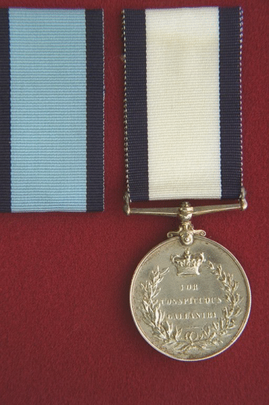 Conspicuous Gallantry Medal (Naval).  The medal is circular, silver, 1.42 inches in diameter.