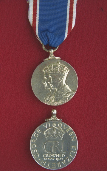 King George VI Coronation Medal (1937).  A circular, silver medal (1.25 inches in diameter).