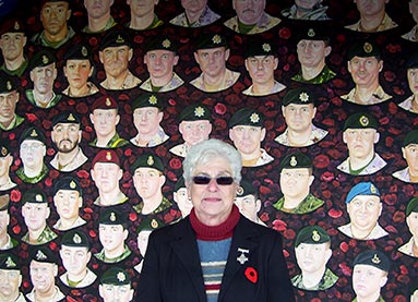 National Memorial (Silver) Cross Mother Mabel Margaret Girouard in front of the collage of Afghanistan Veterans