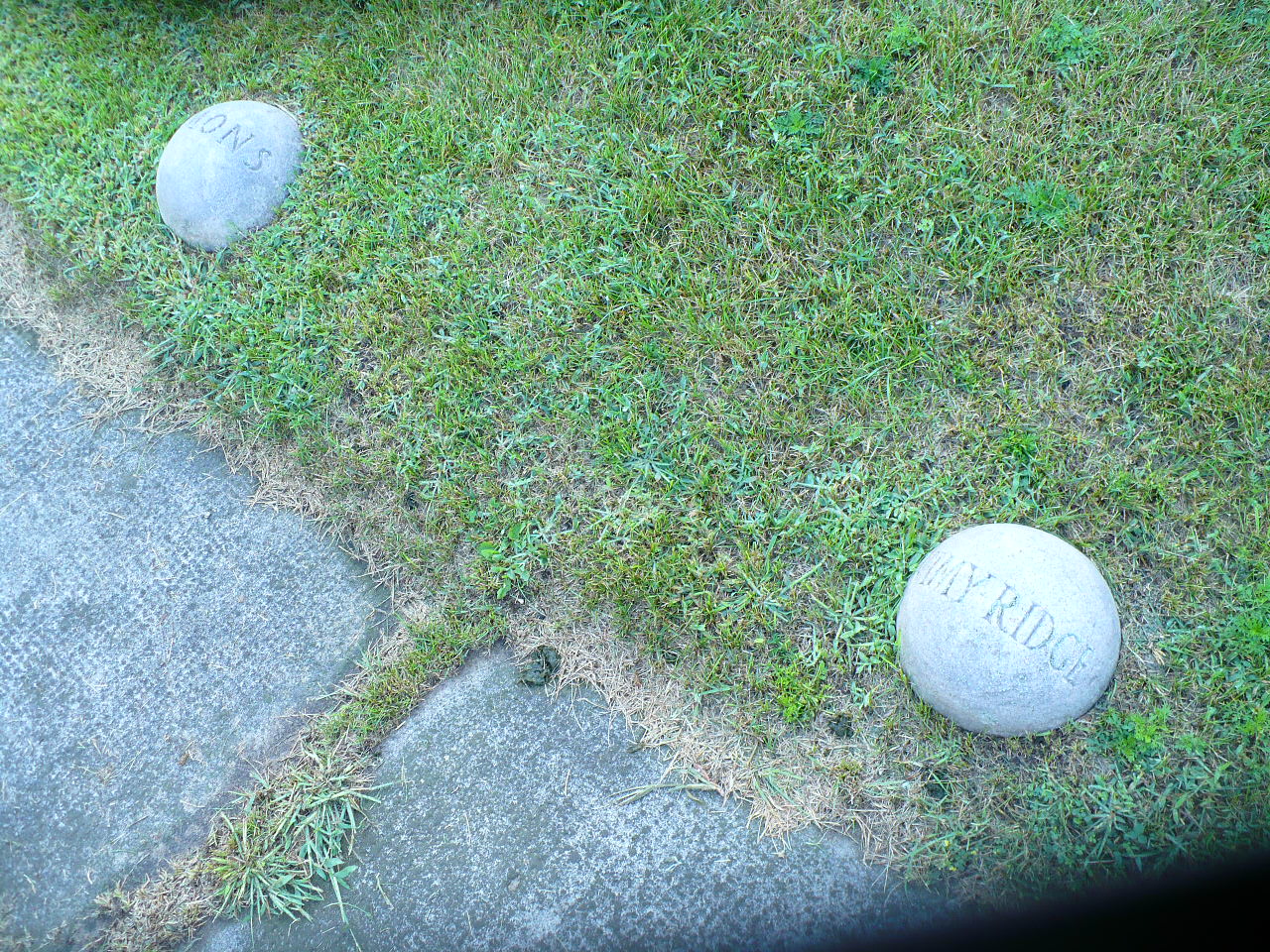 Concrete stones engraved with Mons and Vimy Ridge.