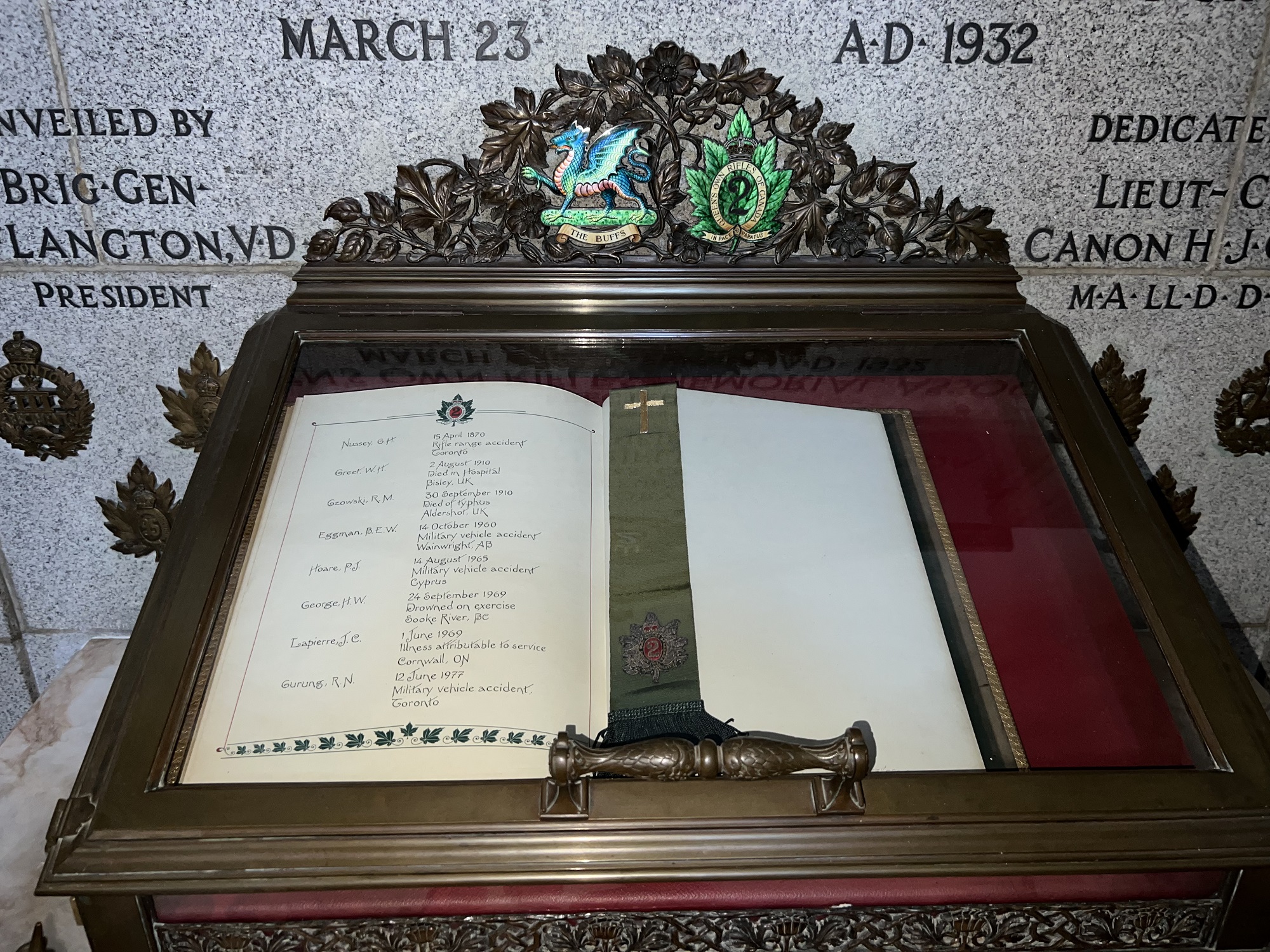 Book of Remembrance in glass and brass case.
