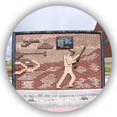 Mural of a soldier and tank made with rocks from the beach of Dieppe.
