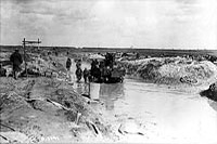 An anti-aircraft gun advancing along a road under water, April 1917.
