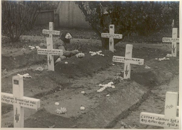 A little girl laying flowers to a fallen Canadian